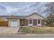 Charming home featuring a brick facade, vinyl siding, solar panels, and a well-kept front lawn at 427 Hickory St, Broomfield, CO 80020