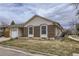 Charming home with a brick facade, vinyl siding, solar panels, attached garage and a well-kept front lawn at 427 Hickory St, Broomfield, CO 80020