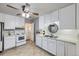 Well-lit kitchen featuring white cabinets and neutral tile flooring, open to back door at 427 Hickory St, Broomfield, CO 80020