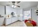 Bright kitchen featuring white cabinets, laminate countertop and a dining area with a ceiling fan at 427 Hickory St, Broomfield, CO 80020