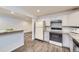 Traditional kitchen with white cabinets and appliances, and stone countertops at 427 Hickory St, Broomfield, CO 80020