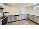 Finished basement featuring a kitchen area with stainless appliances and gray cabinetry at 427 Hickory St, Broomfield, CO 80020