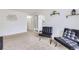 Spacious living room with neutral colored carpet, white walls, and decorative mirror at 427 Hickory St, Broomfield, CO 80020