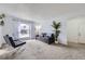 Cozy living room with a comfortable sofa, two leather chairs, lots of natural light and neutral colored carpet at 427 Hickory St, Broomfield, CO 80020