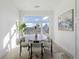 Bright dining area with a round table, large window, and modern decor at 6959 E Lowry Blvd, Denver, CO 80230