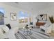 Bright, open living room featuring modern decor and a large window with a neighborhood view at 6959 E Lowry Blvd, Denver, CO 80230