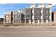 Modern townhomes featuring large windows, brick accents, and a contemporary design at 6959 E Lowry Blvd, Denver, CO 80230