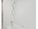 White tub and shower with neutral tile at 7395 E Quincy Ave # 207, Denver, CO 80237