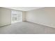 Spacious bedroom with a large window and neutral carpeting at 7395 E Quincy Ave # 207, Denver, CO 80237