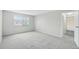 Light and bright bedroom features a window and open doorway leading to a hallway at 7395 E Quincy Ave # 207, Denver, CO 80237