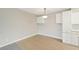 Empty dining area featuring tile floors, neutral paint, and hanging light fixture at 7395 E Quincy Ave # 207, Denver, CO 80237
