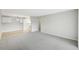 Spacious living room with carpet flooring adjacent to the kitchen at 7395 E Quincy Ave # 207, Denver, CO 80237