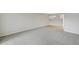 Large living room with gray carpet, and view of kitchen at 7395 E Quincy Ave # 207, Denver, CO 80237