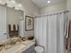 Cozy bathroom featuring a granite-topped sink and a shower with curtain at 3929 Spanish Oaks Trl, Castle Rock, CO 80108
