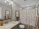 Bathroom with a vanity, shower with floral shower curtain, updated fixtures and decor at 3929 Spanish Oaks Trl, Castle Rock, CO 80108