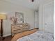 Bright bedroom features a rustic dresser and decor, with luxury vinyl flooring at 3929 Spanish Oaks Trl, Castle Rock, CO 80108