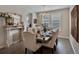 Elegant dining room with a fireplace, chandelier, large windows, and a dining table for eight at 3929 Spanish Oaks Trl, Castle Rock, CO 80108