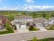 Inviting two-story home featuring a three-car garage, stone accents, and a well-manicured front lawn with mountain views at 3929 Spanish Oaks Trl, Castle Rock, CO 80108