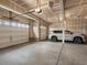 Spacious three car garage with concrete floor and insulated doors has car parked inside at 3929 Spanish Oaks Trl, Castle Rock, CO 80108