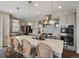 Gourmet kitchen featuring a large island with seating, modern pendant lighting, stainless steel appliances and gray cabinetry at 3929 Spanish Oaks Trl, Castle Rock, CO 80108