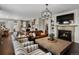 Comfortable living room with a fireplace, television, and views of the kitchen at 3929 Spanish Oaks Trl, Castle Rock, CO 80108