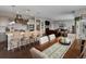 Open-concept kitchen with island seating flows into the living room at 3929 Spanish Oaks Trl, Castle Rock, CO 80108