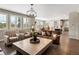 Bright living room features hardwood floors, large windows and comfortable seating at 3929 Spanish Oaks Trl, Castle Rock, CO 80108