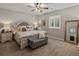 Charming main bedroom featuring a decorative headboard, plush bedding, and a light-filled window at 3929 Spanish Oaks Trl, Castle Rock, CO 80108