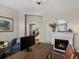 Comfortable office with fireplace, a stylish desk, and hardwood flooring at 3929 Spanish Oaks Trl, Castle Rock, CO 80108