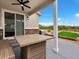 Cozy patio with outdoor seating, grill, and a beautiful view of the backyard at 3929 Spanish Oaks Trl, Castle Rock, CO 80108