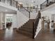 Elegant staircase featuring dark wood steps, wrought iron railing, and hardwood flooring, with an open landing at 3929 Spanish Oaks Trl, Castle Rock, CO 80108