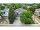 Aerial view of a charming two-story home nestled among mature trees at 505 Orchard Dr, Louisville, CO 80027