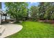 Green backyard boasting a sprawling lawn and patio space for outdoor activities at 505 Orchard Dr, Louisville, CO 80027