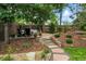 Picturesque backyard landscape with stone walkway and cozy lounge area at 505 Orchard Dr, Louisville, CO 80027