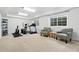 Spacious basement area featuring workout equipment, comfortable seating, and bright windows for a functional space at 505 Orchard Dr, Louisville, CO 80027