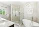 Elegant bathroom featuring a modern tub, glass-enclosed shower, and marble accents, creating a spa-like experience at 505 Orchard Dr, Louisville, CO 80027