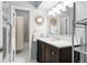 Bathroom showcasing a vanity with double sinks, decorative mirrors, and a shower with a patterned curtain at 505 Orchard Dr, Louisville, CO 80027