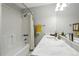 Clean bathroom featuring a shower-tub combo with a bright yellow towel and a sleek vanity with a modern mirror at 505 Orchard Dr, Louisville, CO 80027