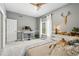 Bright bedroom featuring a comfortable bed, large window with sheer curtains, and a ceiling fan for added comfort at 505 Orchard Dr, Louisville, CO 80027