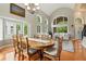 Open dining area with a large table, hardwood floors, and many large windows at 505 Orchard Dr, Louisville, CO 80027