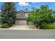 Inviting two-story home featuring a brick and stucco facade with a spacious three-car garage at 505 Orchard Dr, Louisville, CO 80027