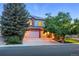 Inviting two-story home featuring a brick and stucco facade with a spacious three-car garage at 505 Orchard Dr, Louisville, CO 80027