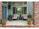 Inviting front porch with potted flowers, comfortable seating, and decorative touches for a welcoming curb appeal at 505 Orchard Dr, Louisville, CO 80027