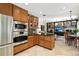 Open kitchen with stainless appliances, adjacent to a cozy living area, perfect for modern living at 505 Orchard Dr, Louisville, CO 80027