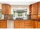 Bright kitchen featuring wood cabinets, granite countertops, stainless steel appliances, and a window above the sink at 505 Orchard Dr, Louisville, CO 80027