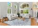 Bright living room boasts large windows, hardwood floors, and vaulted ceilings at 505 Orchard Dr, Louisville, CO 80027