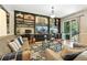 Relaxing living room features a built-in shelving unit, a slider door, and hardwood floors at 505 Orchard Dr, Louisville, CO 80027
