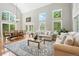 Bright living room with high ceilings, large windows, hardwood floors, and a dining area at 505 Orchard Dr, Louisville, CO 80027