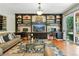 Cozy living room features a built-in shelving unit, a slider door, and hardwood floors at 505 Orchard Dr, Louisville, CO 80027