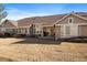 Backyard view featuring a covered patio and mature landscaping at 7679 S Biloxi Way, Aurora, CO 80016